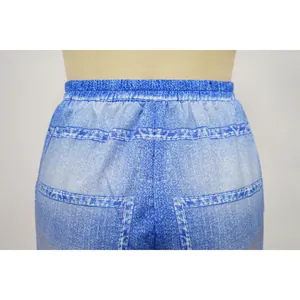Close-up view of the elastic waistband and print detail on denim-style wide leg pants