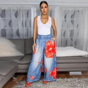 Detail of women's casual wide-leg pants with large red floral print and white tank top