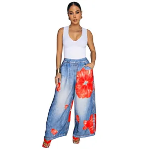 Close-up detail of casual wide-leg denim-style pants featuring bold red floral print