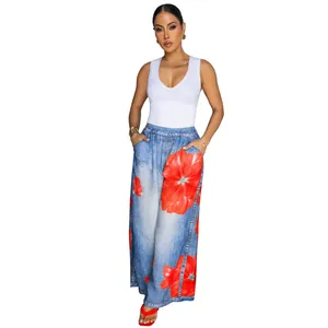Full view of casual wide-leg pants with vibrant red floral print on blue denim-look