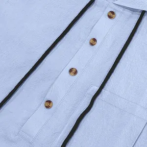 Macro detail of breathable linen henley shirt with wood-tone buttons and drawstrings