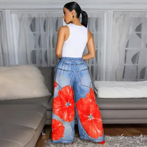 Rear view of women's blue denim-style wide-leg pants featuring vibrant red floral prints