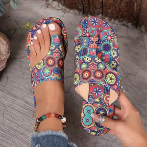 Detailed view of women's ethnic style flat toe-loop slippers with vibrant mandala print