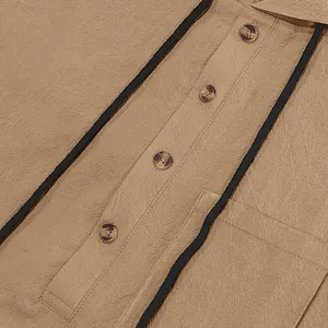 Close-up of linen fabric texture and marble buttons on a tan men's Henley shirt.
