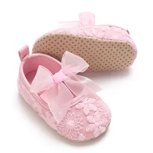 Detailed view of pink floral lace baby walking shoes with soft anti-slip sole and bow