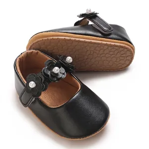 Detail view of black baby girl princess shoes with soft PU sole and floral decor
