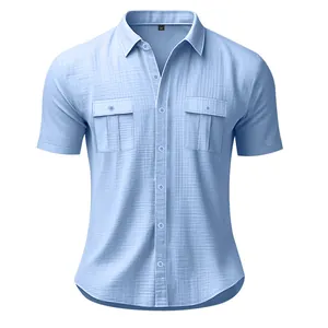 Detail of light blue short sleeve linen shirt with dual chest pockets and texture.