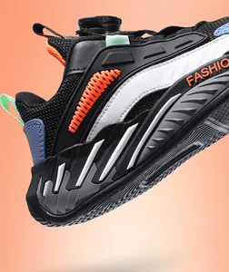 Detailed view of kids' athletic shoe with rotating buckle closure and breathable mesh.