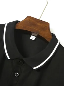 Close-up of black men's polo shirt with white striped ribbed collar and buttons