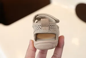 Macro detail view showing the breathable mesh heel and soft sole of beige baby walking sandals