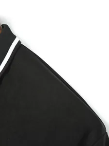 Close-up of black sports polo shirt showing rib collar and white stripe detail