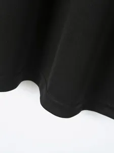 Close-up detail of black breathable mesh fabric and hem stitching on men's sport polo shirt.