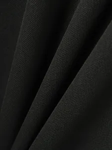 Close-up view of the premium black ribbed fabric texture for men's athletic polo shirt