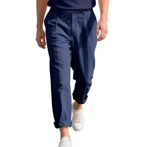 Detail of blue linen casual trousers with drawstring waist and straight-leg cut.