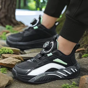 Breathable boys mesh sneakers with rotary buckle dial system in black and white