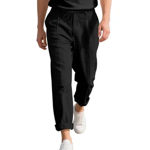 Close-up detail of men's loose black linen straight-leg trousers featuring drawstring waist