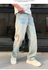 Close-up detail of men's loose light blue denim pants with stylish graffiti art print