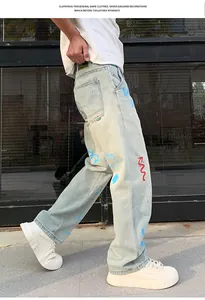 Detailed view of men's light blue straight-leg jeans with vibrant graffiti prints.