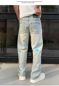 Detail of light blue men's loose jeans with blue graffiti prints and heart design