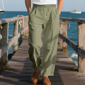 Detail of men's loose breathable linen pants in light olive green with drawstring waist