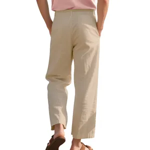 Back view of men's loose beige linen trousers showing breathable fabric texture