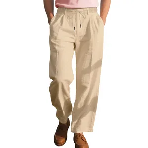 Close-up of men's beige linen trousers featuring a relaxed straight fit and drawstring