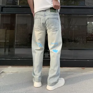 Loose light blue men's straight jeans with graffiti print shown from the back view