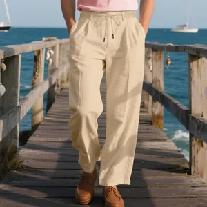 Macro detail of men's loose beige linen trousers with drawstring waist on wooden pier