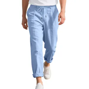 Detail view of men's breathable light blue linen trousers with drawstring waist.