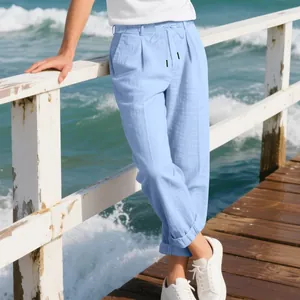 Light blue men's linen casual trousers with drawstring waist on seaside pier