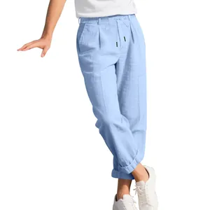 Detail of light blue breathable linen trousers for men with drawstring waist closure.