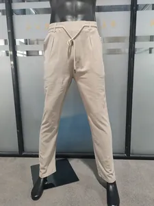 Full front view of beige linen drawstring trousers on mannequin showing loose fit