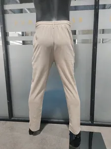 Detailed back view of these men's loose casual linen straight pants in a beige color