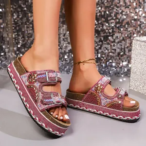 Detailed view of pink platform sandals decorated with rhinestones and white pearls