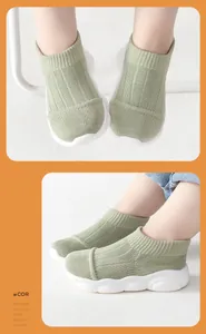 Detailed view of baby sock-style walking shoes with knit upper and thick white sole