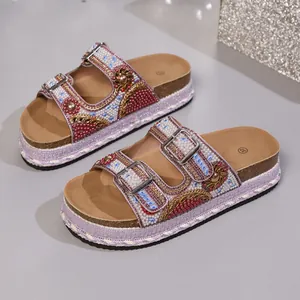Detailed view of rhinestone and bead embellishments on double buckle platform cork slides