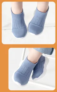 Close-up detail of blue knit baby sock shoes showing the breathable fabric and flexible sole.