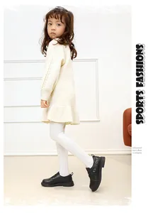 Detailed view of young girl wearing stylish black genuine leather shoes with heart motif