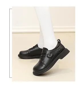 Close-up of girls' black leather shoes featuring heart pattern and non-slip thick sole