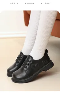 Detail of girls' black leather shoes with heart embroidery and non-slip sole