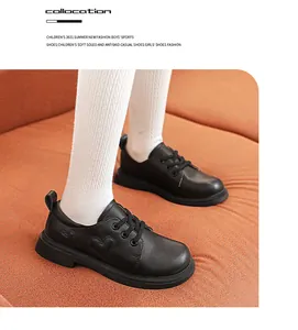 Close-up view of black girl's leather shoes featuring heart pattern stitching detail