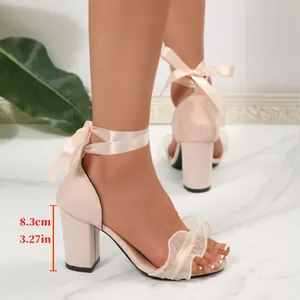 Close-up of nude block heel sandals with ribbon ankle ties and an 8.3cm high heel.