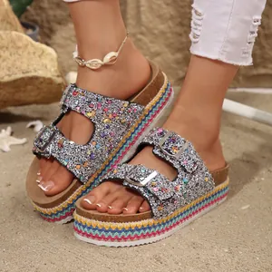 Close-up of glitter platform sandals with colorful ethnic braided sole detail