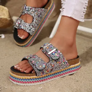 Close-up of ethnic style platform sandals with colorful glitter and double buckles