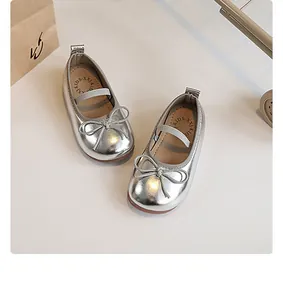 Top view of shiny silver girls Mary Jane princess shoes with delicate bow detail