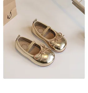 Detailed overhead shot showing the metallic finish and bow of gold girls princess shoes