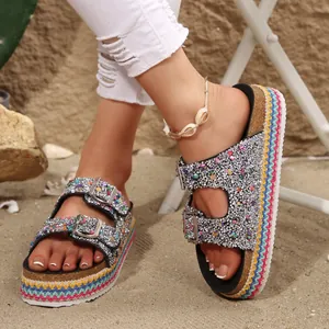Close-up of ethnic platform sandals featuring colorful glitter and double buckles