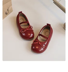 Detailed top-down view of red girls' Mary Jane princess shoes featuring a cute bow and soft sole