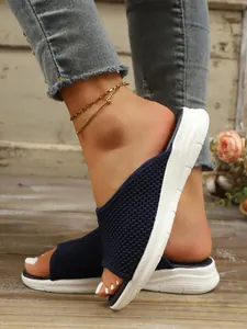 Gros plan sur la tige en maille bleu marine respirante de sandales plates pour femmes