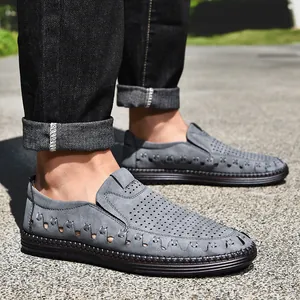 Détail de mocassins en cuir gris perforé pour hommes avec finitions à la main